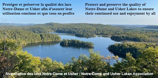 view of still water of lake says Preserve and protect the quality of the lakes and watershed to ensure their continued use and enjoyment by all with title Lac Notre-Dame and Usher Lake Association