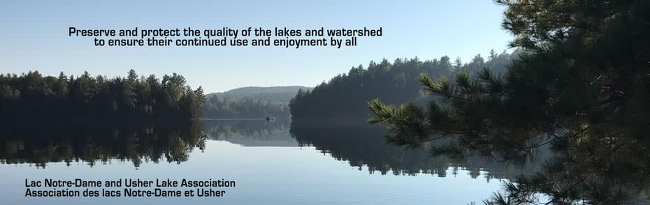 view of still water of lake says Preserve and protect the quality of the lakes and watershed to ensure their continued use and enjoyment by all with title Lac Notre-Dame and Usher Lake Association